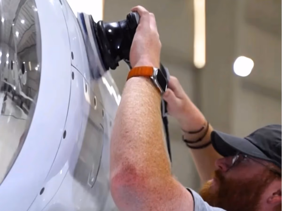 Machine polishing the white paint of an aircraft