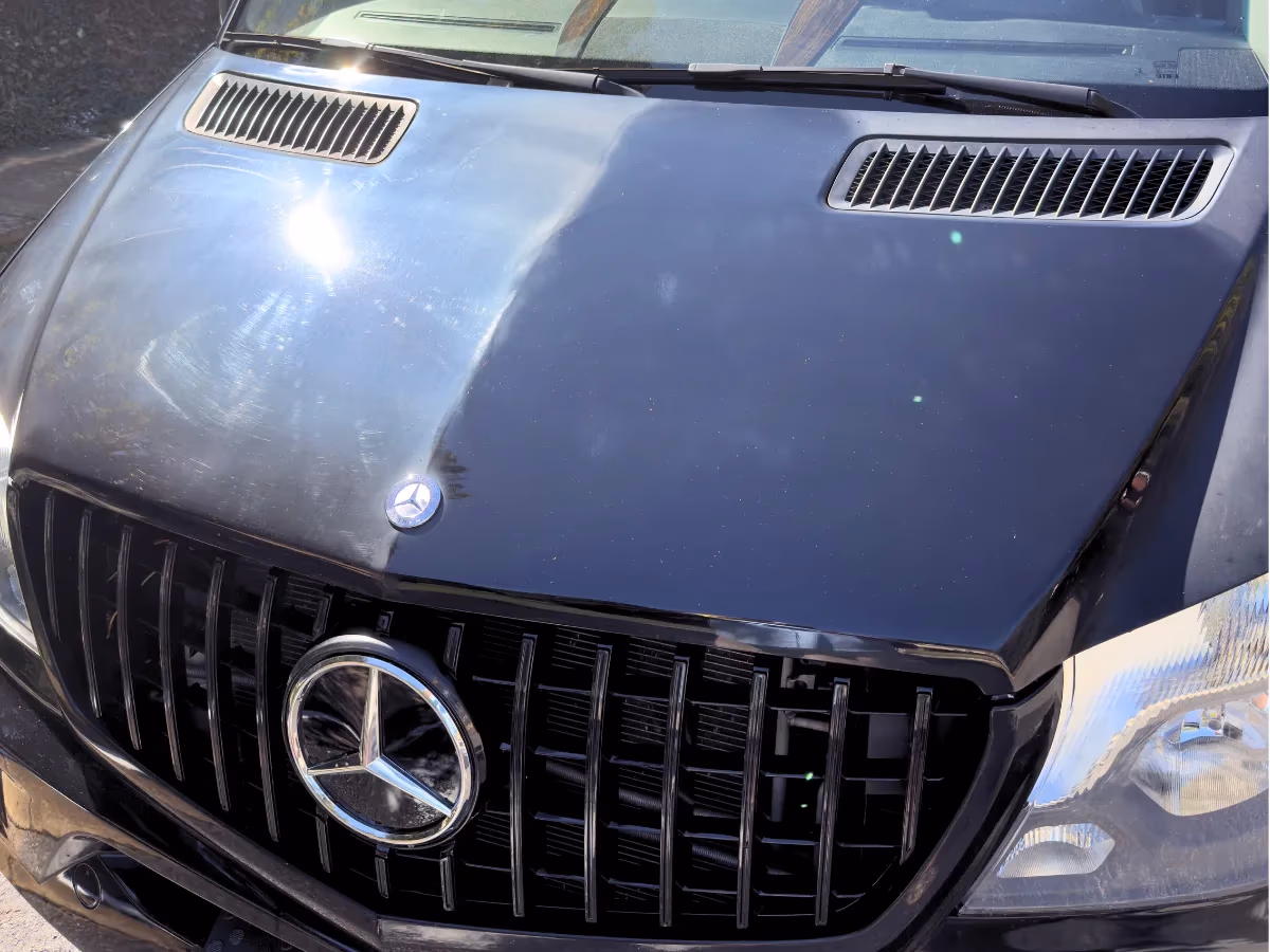 Black Mercedes hood corrected down the center, before and after