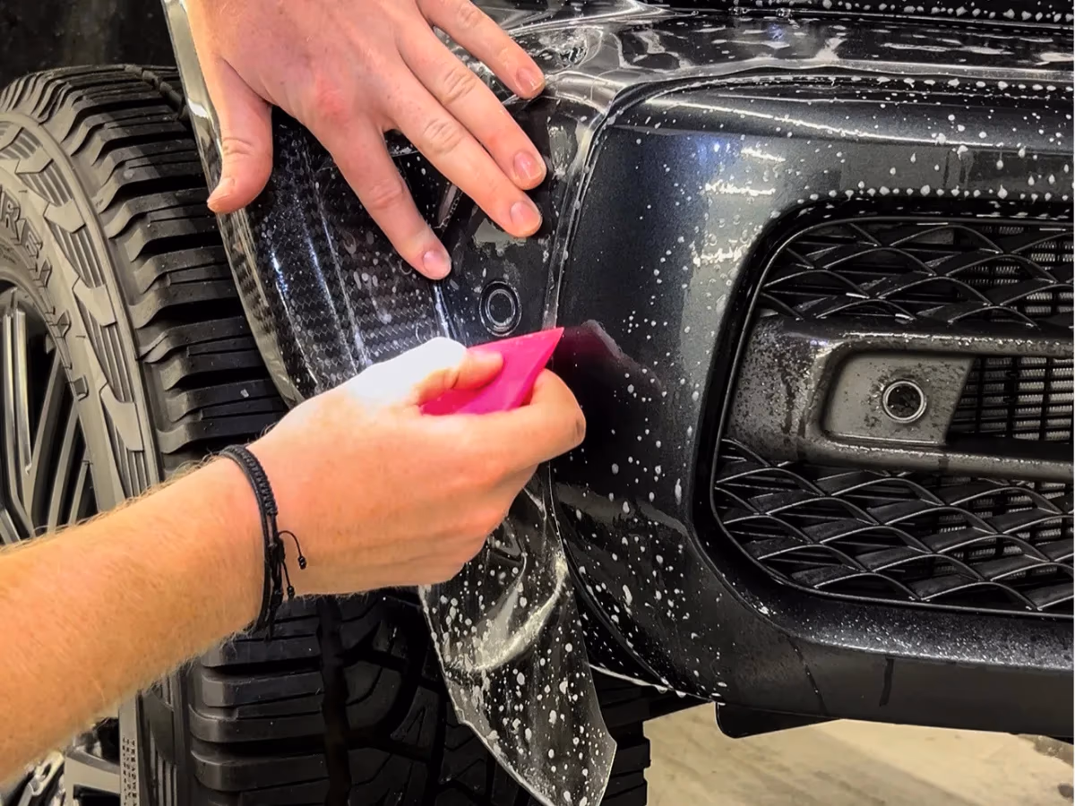 Paint protection film installed around a front-bumper radar sensor