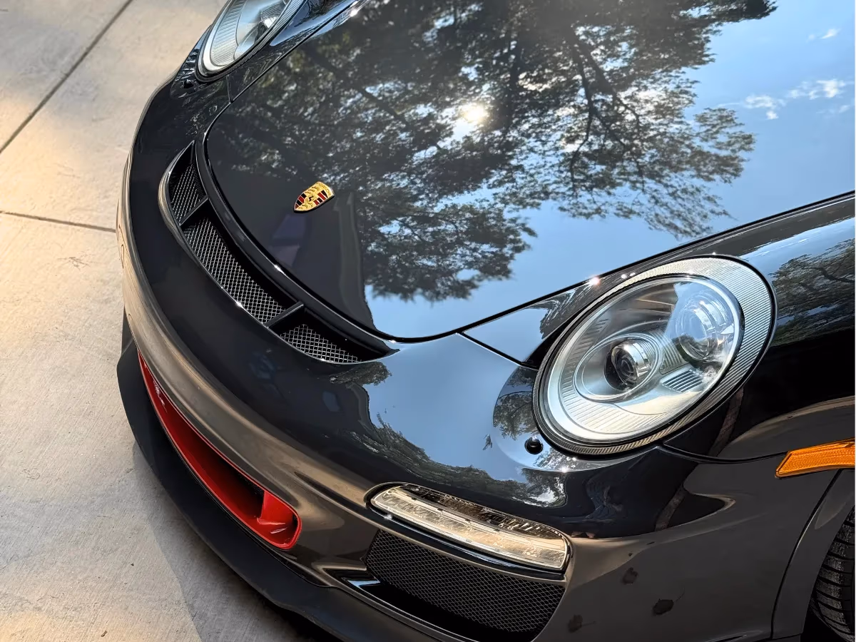 Black Porsche hood protected with paint protection film